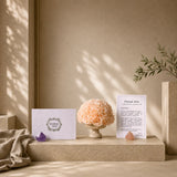 Champagne-preserved rose arrangement styled in a sculptural travertine funnel vase.