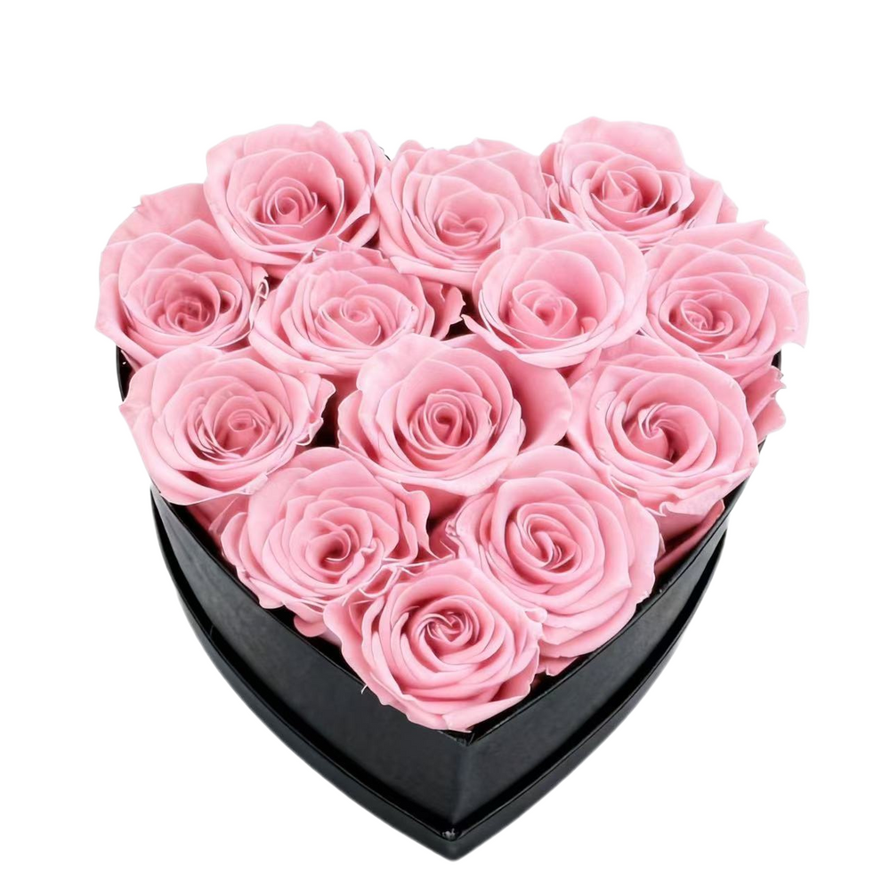 A luxurious heart box filled with 13 or 20 handcrafted forever roses, featuring a Parisian black hat-box design with gold detailing. Bloom 3+ years.