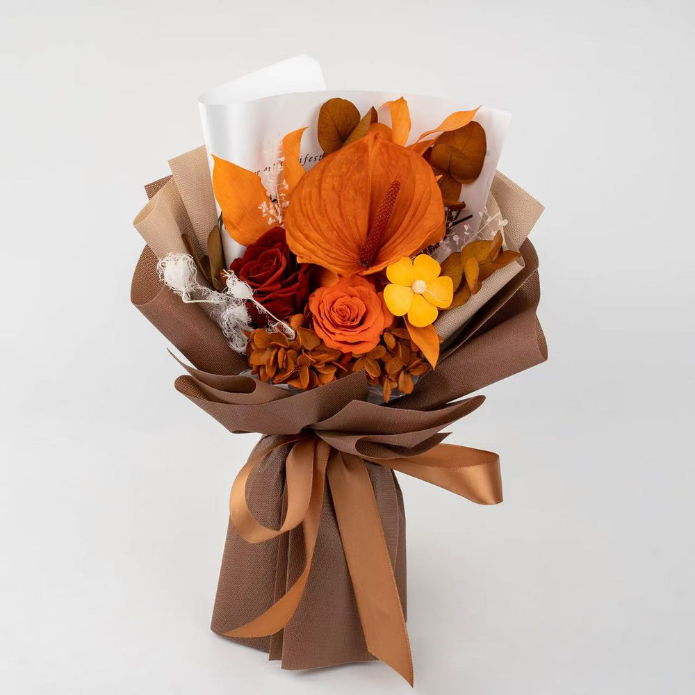 This elegant preserved flower bouquet features vibrant anthuriums, roses, and soft hydrangeas wrapped in rich tones. A perfect long-lasting gift for birthdays, anniversaries, or fall celebrations — exuding warmth, luxury, and timeless beauty in every detail.